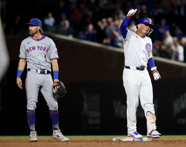 Chicago Cubs right fielder Seiya Suzuki (27) celebrates at second base after driving in a run on a double in the third inning of a game against the New York Mets at Wrigley Field in Chicago on Sept. 24, 2025. (Chris Sweda/Chicago Tribune)