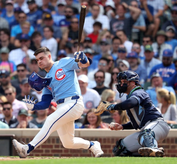 Chicago Cubs third baseman Matt Shaw catches his helmet after a big swing in the second inning of a game against the Tampa Bay Rays at Wrigley Field in Chicago on Sept. 12, 2025. (Chris Sweda/Chicago Tribune)