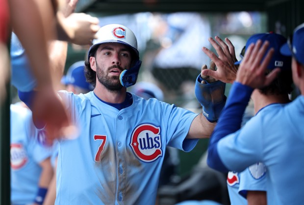 Chicago Cubs shortstop Dansby Swanson (7) is congratulated by his teammates in the dugout after scoring a run on a single by Michael Busch in the second inning of a game against the Tampa Bay Rays at Wrigley Field in Chicago on Sept. 12, 2025. (Chris Sweda/Chicago Tribune)