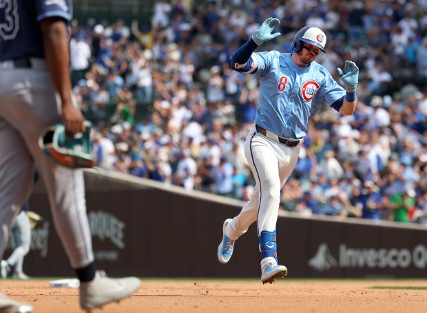 Chicago Cubs left fielder Ian Happ celebrates as he rounds the bases after hitting a solo home run in the fourth inning of a game against the Tampa Bay Rays at Wrigley Field in Chicago on Sept. 12, 2025. (Chris Sweda/Chicago Tribune)