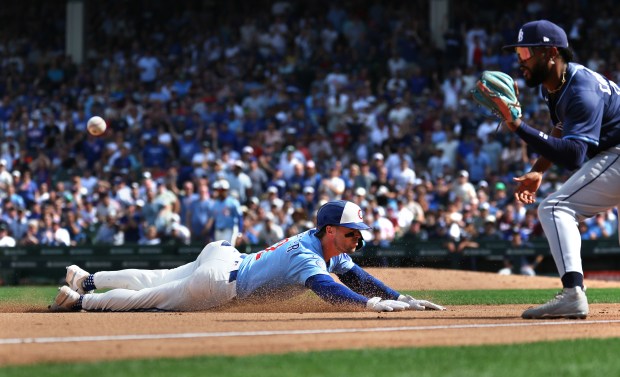 Chicago Cubs second baseman Nico Hoerner slides into third base with a triple in the fourth inning of a game against the Tampa Bay Rays at Wrigley Field in Chicago on Sept. 12, 2025. (Chris Sweda/Chicago Tribune)
