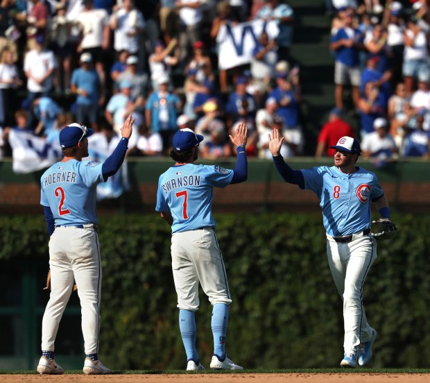 Chicago Cubs players Nico Hoerner (2), Dansby Swanson (7), and Ian Happ (8), celebrate after a victory over the Tampa Bay Rays at Wrigley Field in Chicago on Sept. 12, 2025. (Chris Sweda/Chicago Tribune)
