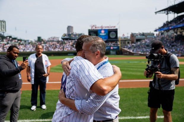 Former Cubs first baseman Anthony Rizzo talks with Chairman Tom Ricketts before the Cubs play the Tampa Bay Rays at Wrigley Field after the Cubs announced he would retire and become an ambassador for the team he helped lead to a World Series in 2016 Saturday Sept. 13, 2025, in Chicago. (Armando L. Sanchez/Chicago Tribune)