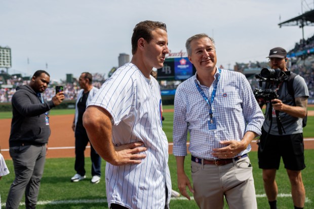Former Cubs first baseman Anthony Rizzo talks with Chairman Tom Ricketts before the Cubs play the Tampa Bay Rays at Wrigley Field after the Cubs announced he would retire and become an ambassador for the team he helped lead to a World Series in 2016 Saturday Sept. 13, 2025, in Chicago. (Armando L. Sanchez/Chicago Tribune)