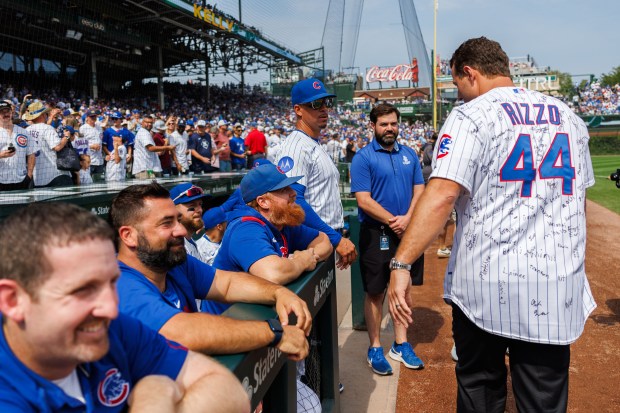 Former Cubs first baseman Anthony Rizzo walks past the team dugout before the Cubs play the Tampa Bay Rays at Wrigley Field after the Cubs announced he would retire and become an ambassador for the team he helped lead to a World Series in 2016 Saturday Sept. 13, 2025, in Chicago. (Armando L. Sanchez/Chicago Tribune)