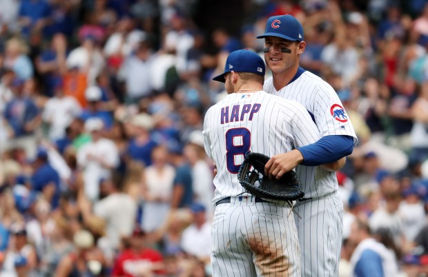 Chicago Cubs first baseman Anthony Rizzo (44) and Ian Happ celebrate the win Sunday, July 1, 2018 at Wrigley Field. The Cubs defeated the Twins, 11-10. (Brian Cassella/Chicago Tribune)