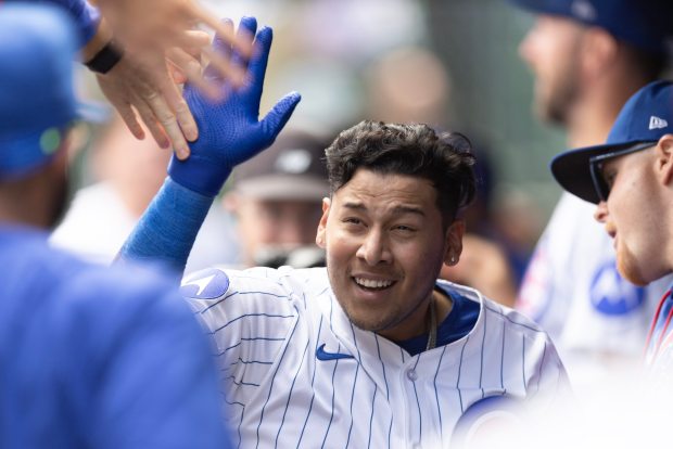 Cubs designated hitter Moisés Ballesteros high-fives teammates in the dugout after hitting a solo home run in the second inning against the Rays on Sept. 13, 2025, at Wrigley Field. It was his first major-league home run. (Geoff Stellfox/Getty Images)