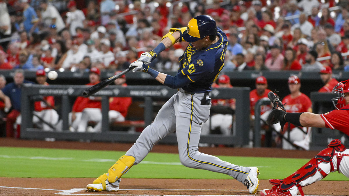 Milwaukee Brewers designated hitter Christian Yelich (22) hits a single against the St. Louis Cardinals during the first inning at Busch Stadium. 