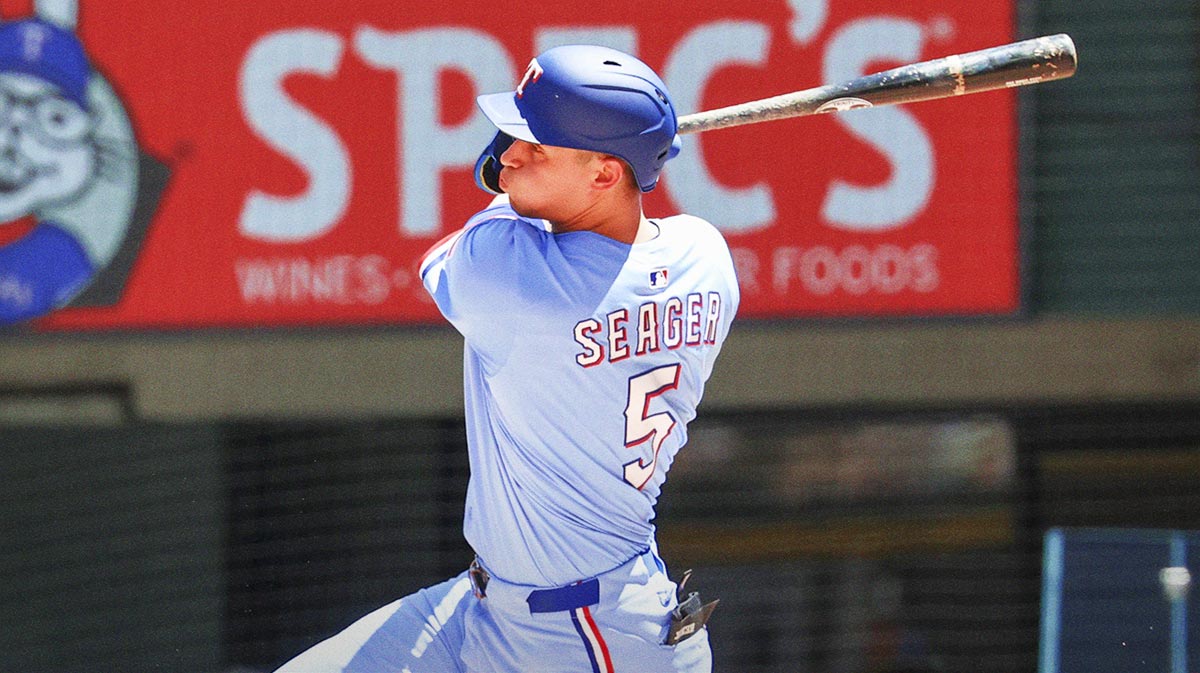 Texas Rangers shortstop Corey Seager (5) hits a two-run single during the third inning against the Seattle Mariners at Globe Life Field.