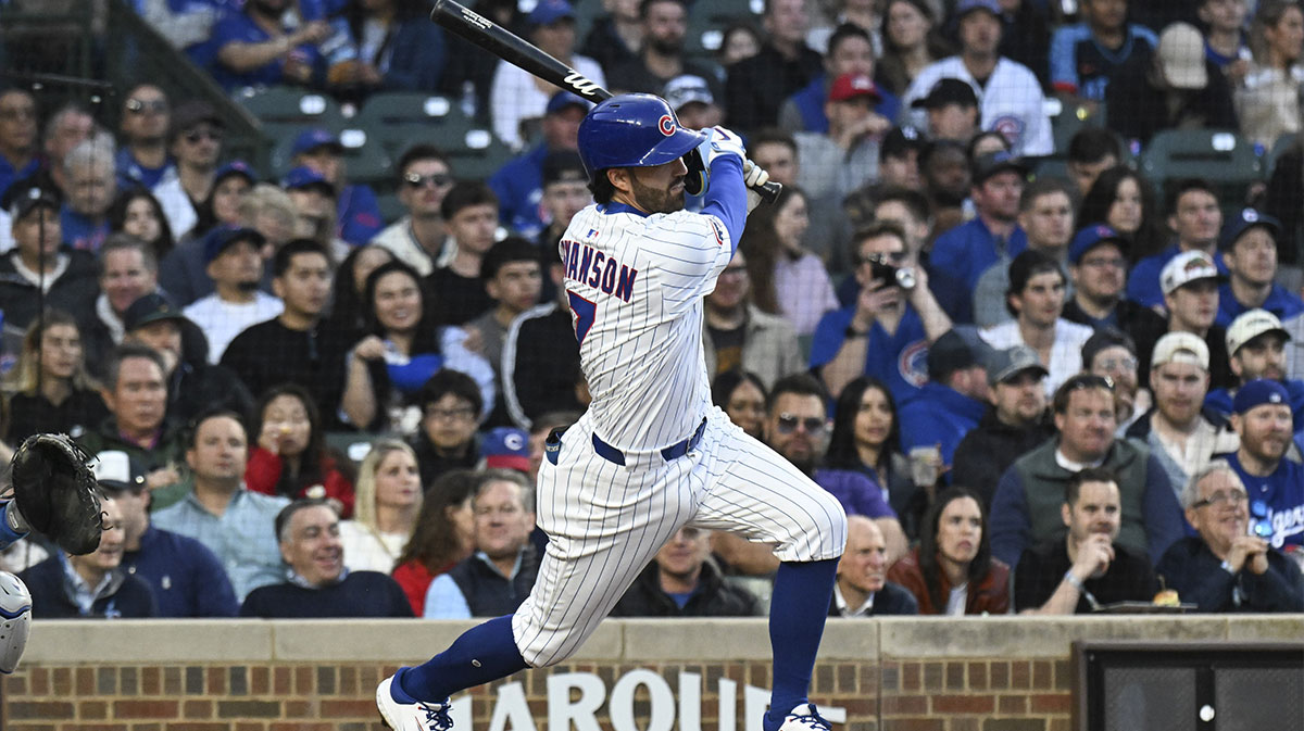 Chicago Cubs shortstop Dansby Swanson (7) singles during the fourth inning against the Los Angeles Dodgers at Wrigley Field.