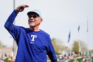 Texas Rangers manager Bruce Bochy salutes the crowd during ceremonies commemorating his...
