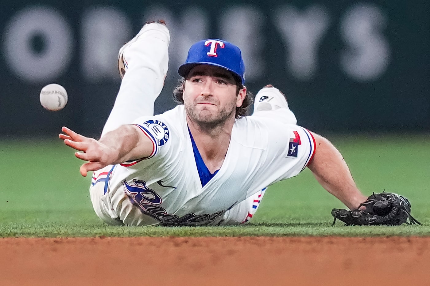 Texas Rangers shortstop Josh Smith flips the ball to second base but can’t get an out on a...