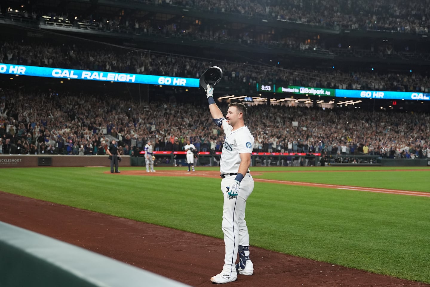 The Mariners' Cal Raleigh waves to the crowd after hitting his 60th home run of the season on Wednesday night.