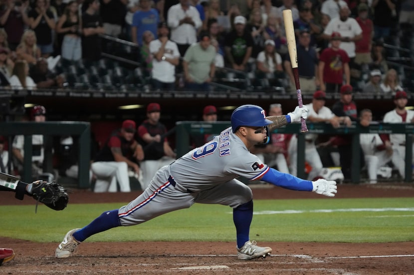 Texas Rangers' Cody Freeman hits an RBI single against the Arizona Diamondbacks in the 10th...