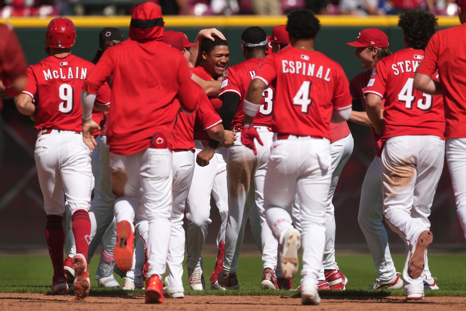 Cincinnati Reds' Noelvi Marte, center, celebrates with teammates after hitting a walkoff two-run single in the ninth inning of a baseball game against the Toronto Blue Jays, Monday, Sept. 1, 2025, in Cincinnati. (AP Photo/Kareem Elgazzar)