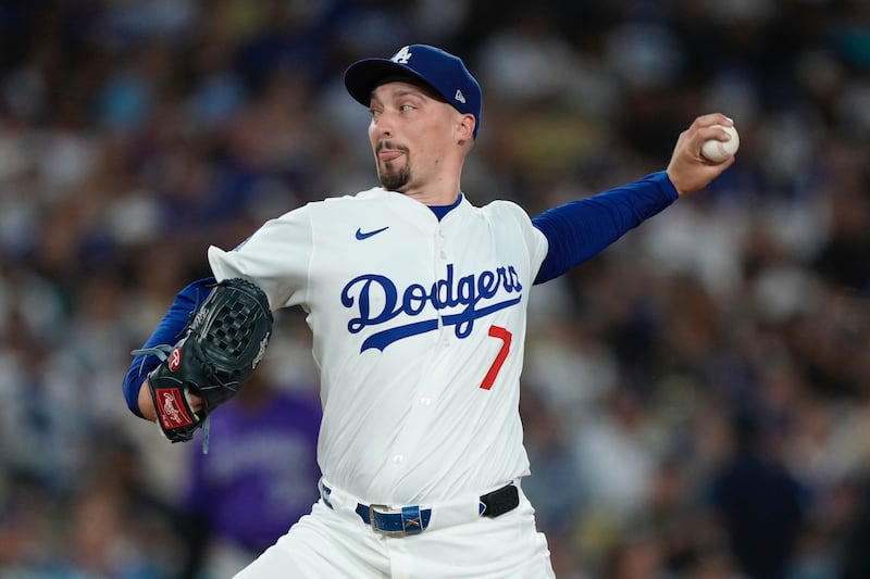 Photo of a Dodgers baseball player throwing a pitch.