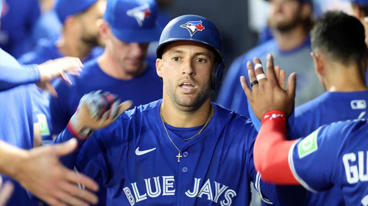 Toronto Blue Jays designated hitter George Springer (4) is congratulated after he scored a run during the first inning against the Tampa Bay Rays at George M. Steinbrenner Field.