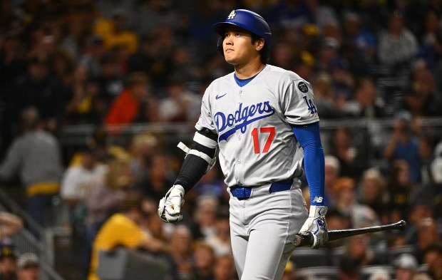 Dodgers star Shohei Ohtani walks to the dugout after striking...