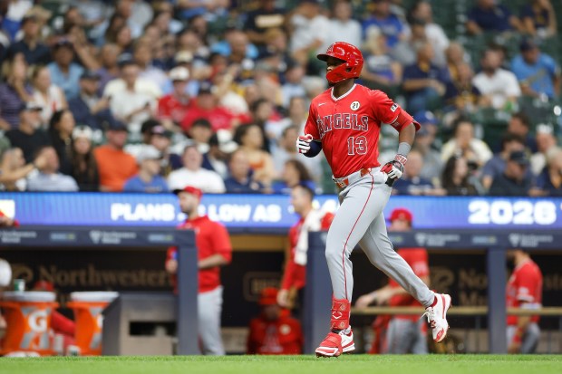 Angels rookie Denzer Guzman runs the bases after hitting a...