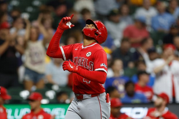 Angels rookie Christian Moore gestures before crossing home plate after...