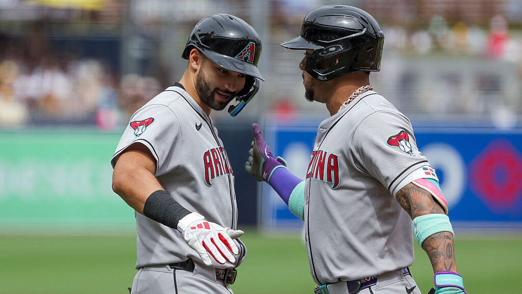 Jordan Lawlar #10 and Ketel Marte #4 of the Arizona Diamondbacks...