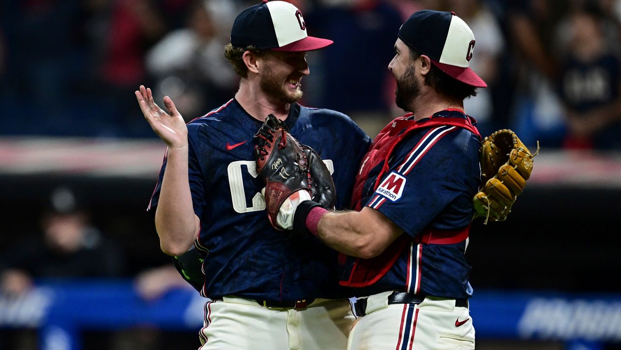 Cleveland Guardians starting pitcher Tanner Bibee, left, is congratulated by catcher Austin Hedges after the Guardians defeated the Chicago White Sox in a baseball game, Friday, Sept. 12, 2025, in Cleveland.