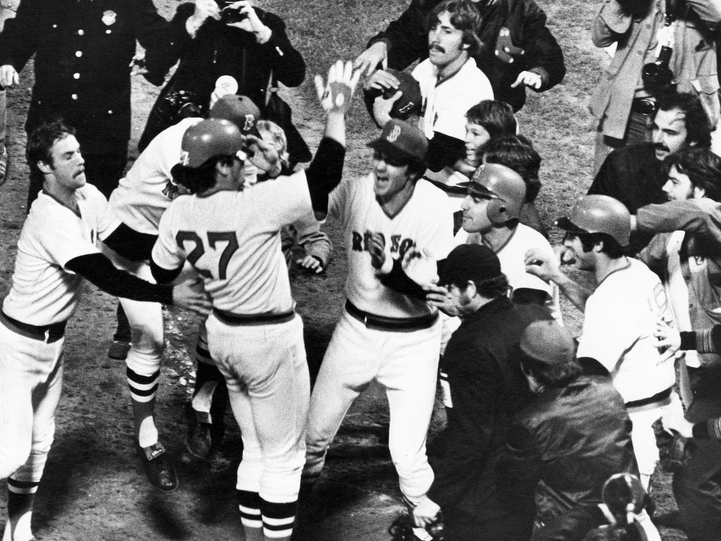 Red Sox catcher Carlton Fisk (center) received a hero's welcome at home plate after his walkoff home run in Game 6.