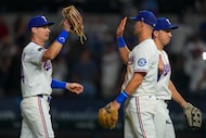 Texas Rangers outfielder Michael Helman, left, reacts with third baseman Josh Jung following...