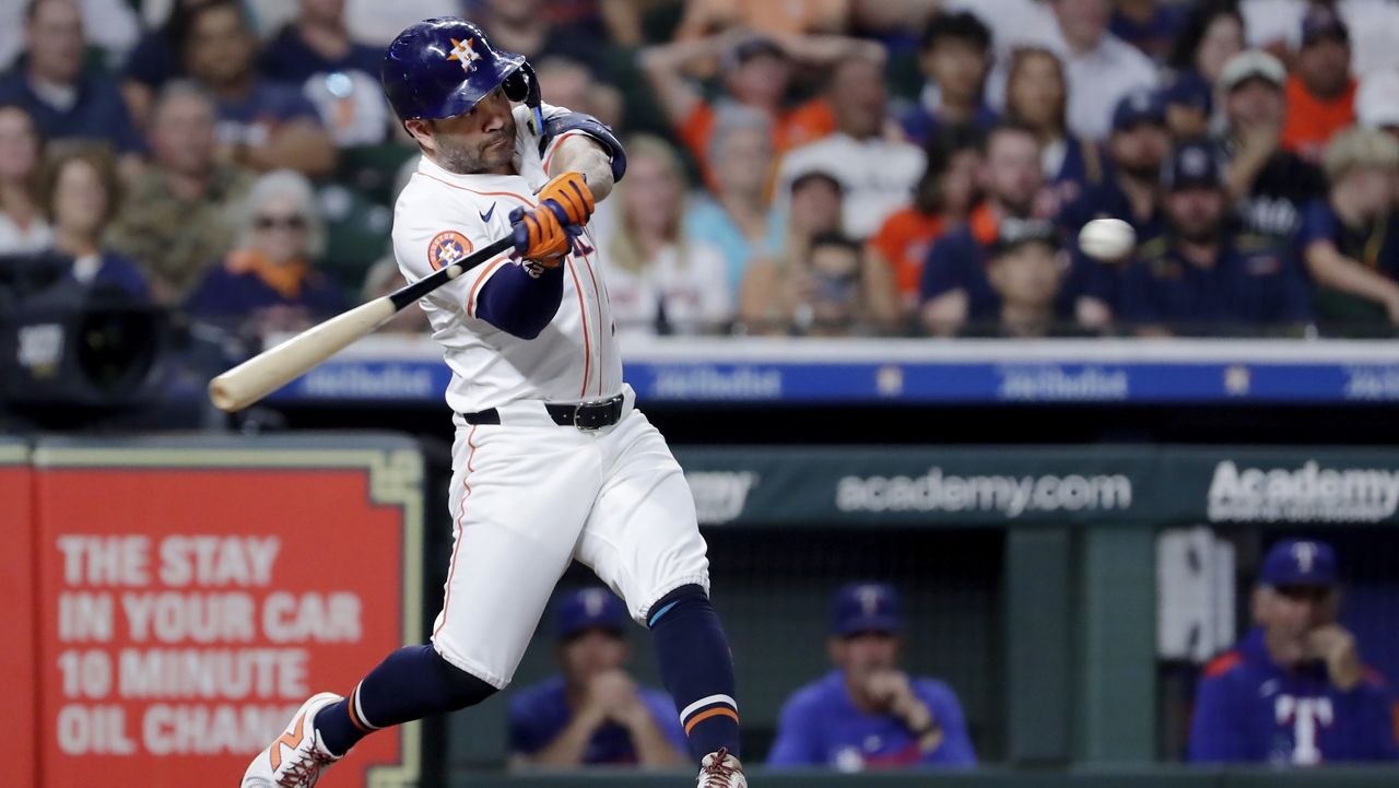 Houston Astros' Jose Altuve swings on his two run home run against the Texas Rangers during the third inning of a baseball game Wednesday, Sept. 17, 2025, in Houston. (AP Photo/Michael Wyke)