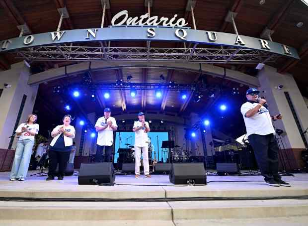 Ontario mayor Paul Leon, right, speaks to the crowd, as...