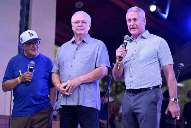 Former Dodgers Steve Sax, right,, speaks to the crowd as...