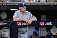 Texas Rangers manager Bruce Bochy looks on from the dugout during the sixth inning of a...