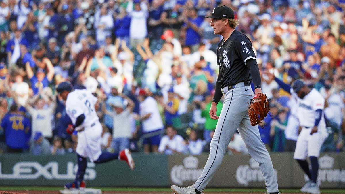 Aug 6, 2025; Seattle, Washington, USA; Chicago White Sox starting pitcher Jonathan Cannon (48) walks to the mound after surrendering a two-run home run to Seattle Mariners first baseman Josh Naylor (12, background during the first inning at T-Mobile Park. 