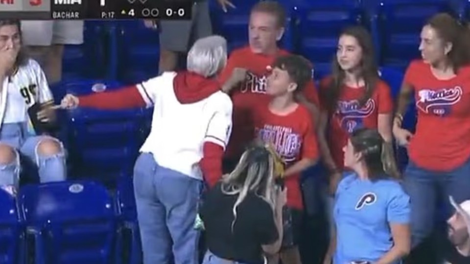 A woman confronts Phillies fans at a baseball game.