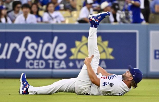 Dodgers starting pitcher Clayton Kershaw stretches before their game against...