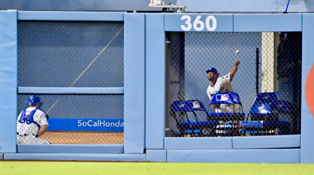 Dodgers starting pitcher Clayton Kershaw warms up in the bullpen...