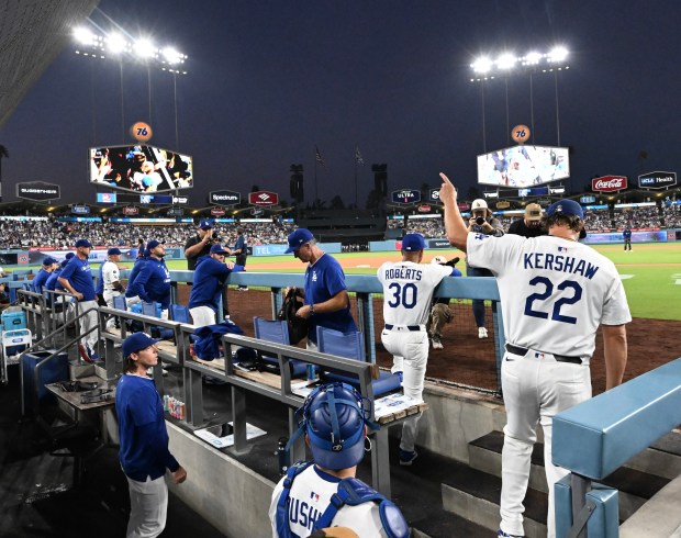 Dodgers starting pitcher Clayton Kershaw acknowledges the crowd before running...