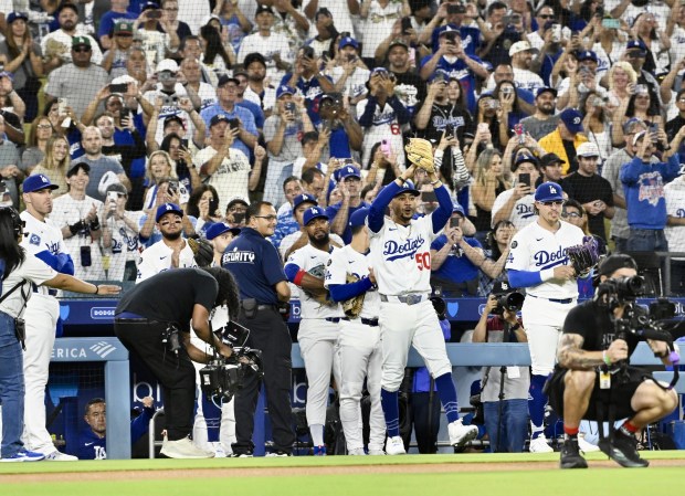 Teammates react as Dodgers starting pitcher Clayton Kershaw, not pictured,...