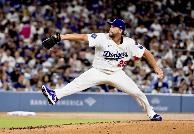 Dodgers starting pitcher Clayton Kershaw throws to the plate during...