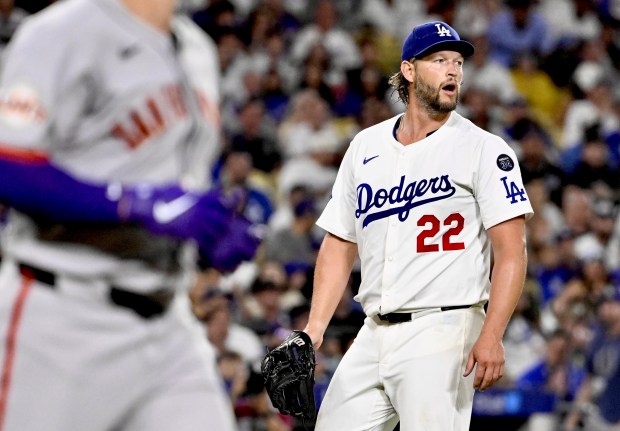 Dodgers starting pitcher Clayton Kershaw looks on between batters during...