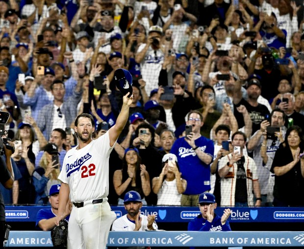 Dodgers starting pitcher Clayton Kershaw waves to the crowd after...