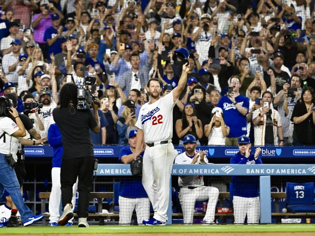 Dodgers starting pitcher Clayton Kershaw waves to the crowd after...