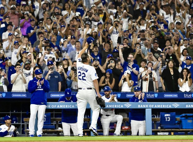 Dodgers starting pitcher Clayton Kershaw waves to the crowd after...