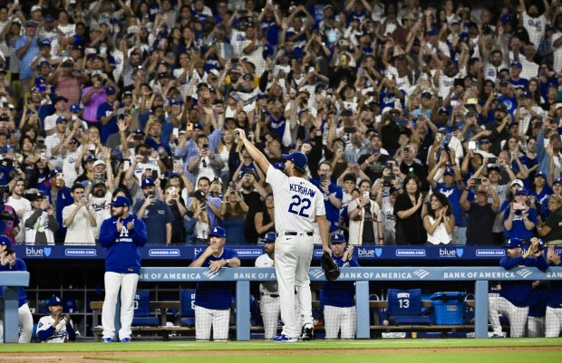 Dodgers starting pitcher Clayton Kershaw waves to the crowd after...