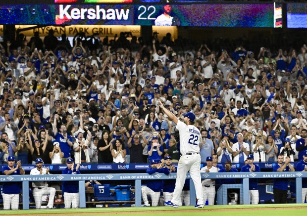 Dodgers starting pitcher Clayton Kershaw waves to the crowd after...
