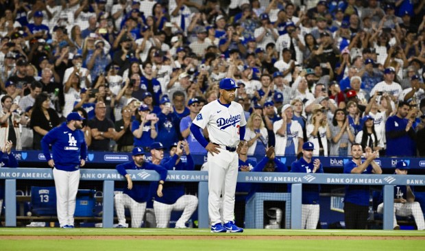 Dodgers manager Dave Roberts waits for starting pitcher Clayton Kershaw...