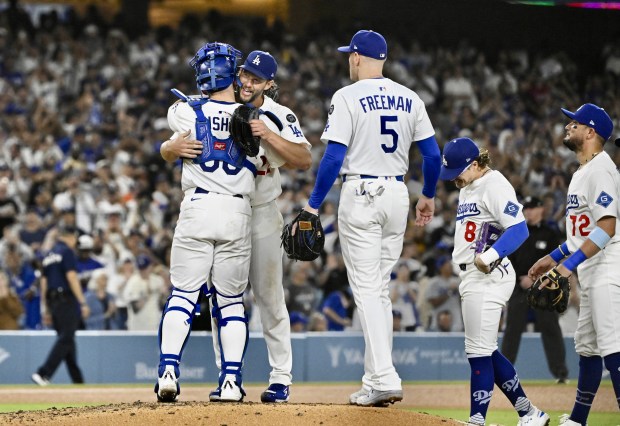 Dodgers starting pitcher Clayton Kershaw, right, hugs catcher Dalton Rushing...