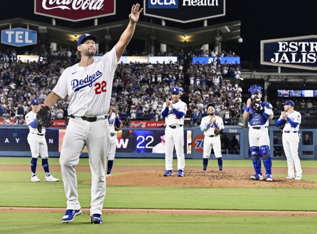Dodgers starting pitcher Clayton Kershaw waves to the crowd after...