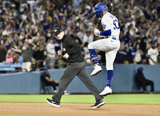 Mookie Betts #50 of the Los Angeles Dodgers celebrates after...