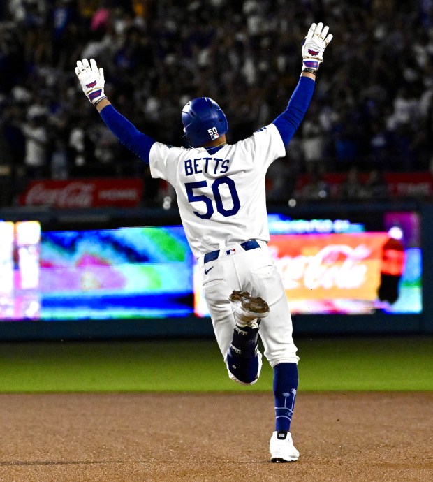 Mookie Betts #50 of the Los Angeles Dodgers celebrates after...
